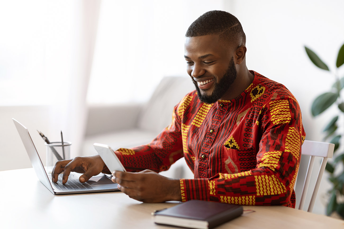 African American man using voip on computer while at home