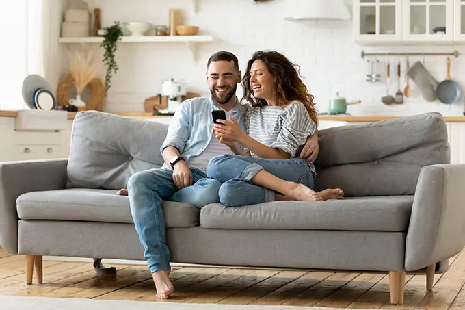 couple-on-couch-using-phone-at-home