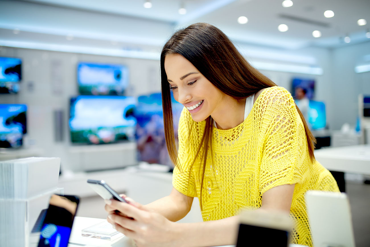 Young woman at store using phone