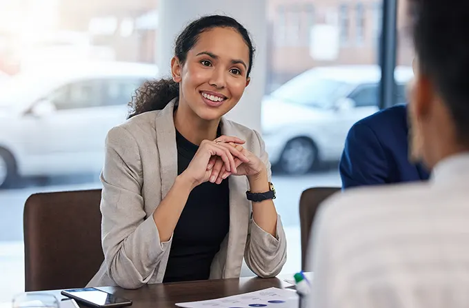 Insurance agent working with client at desk