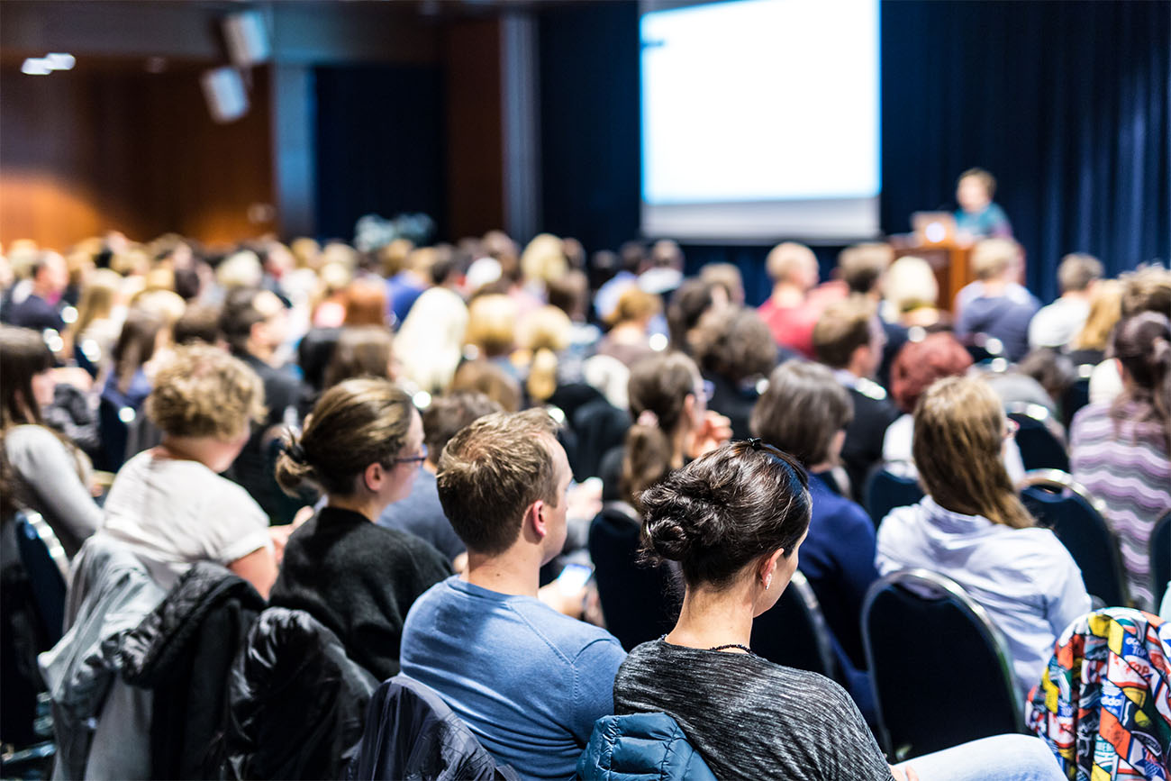 Man presenting in front of live audience