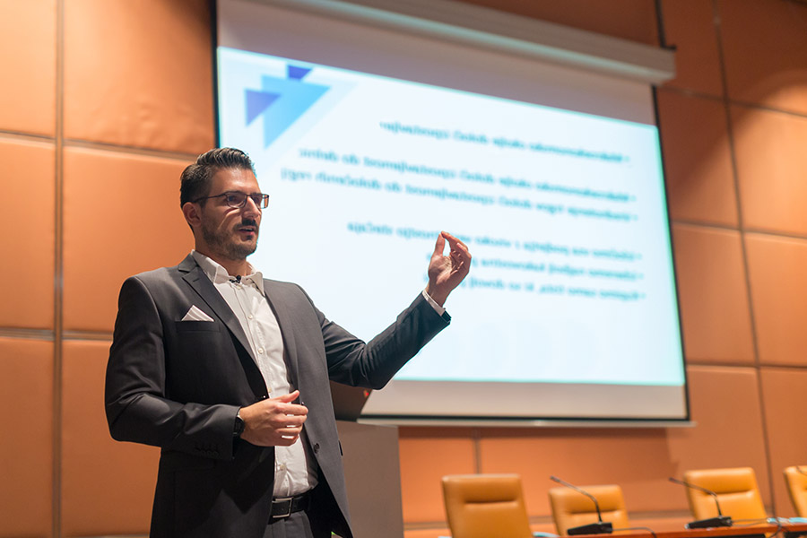 Sales executive holding speech in front of live audience