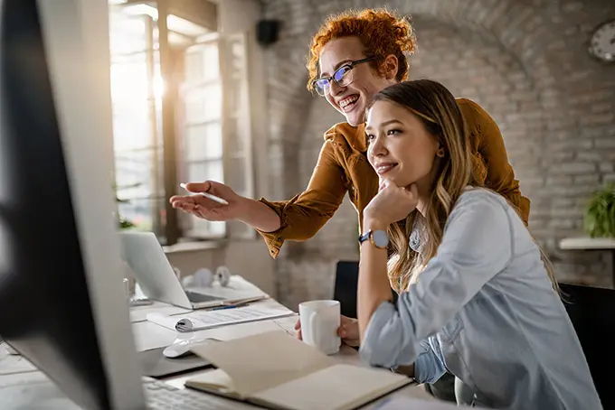 team-of-two-marketing-professionals-looking-at-computer