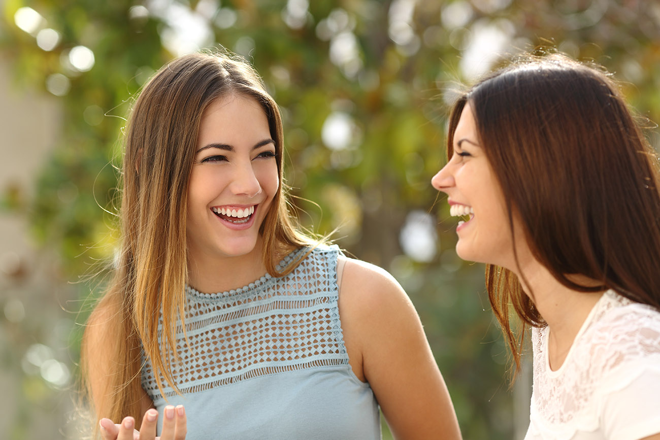 Two happy woman discussing company experience
