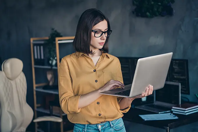 woman using computer standing at home