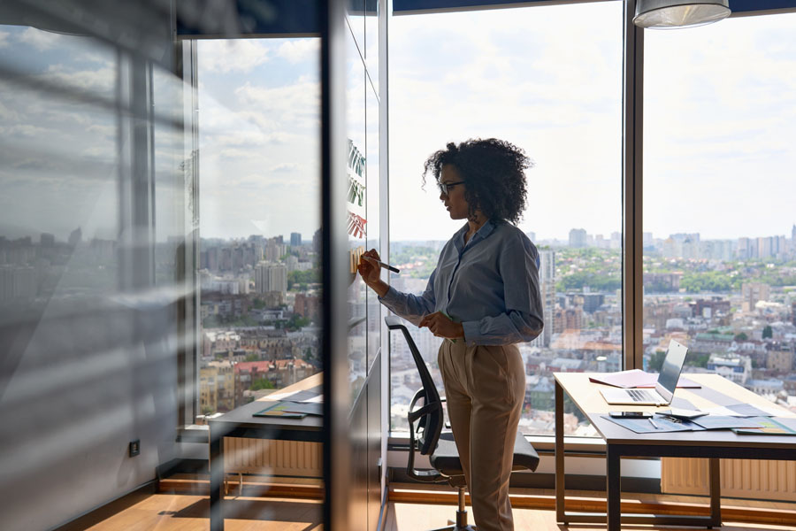 woman-writing-inbound-outbound-tactics-on-board