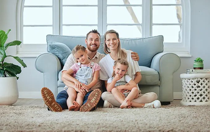 young-family-sitting-on-floor-holding-each-other