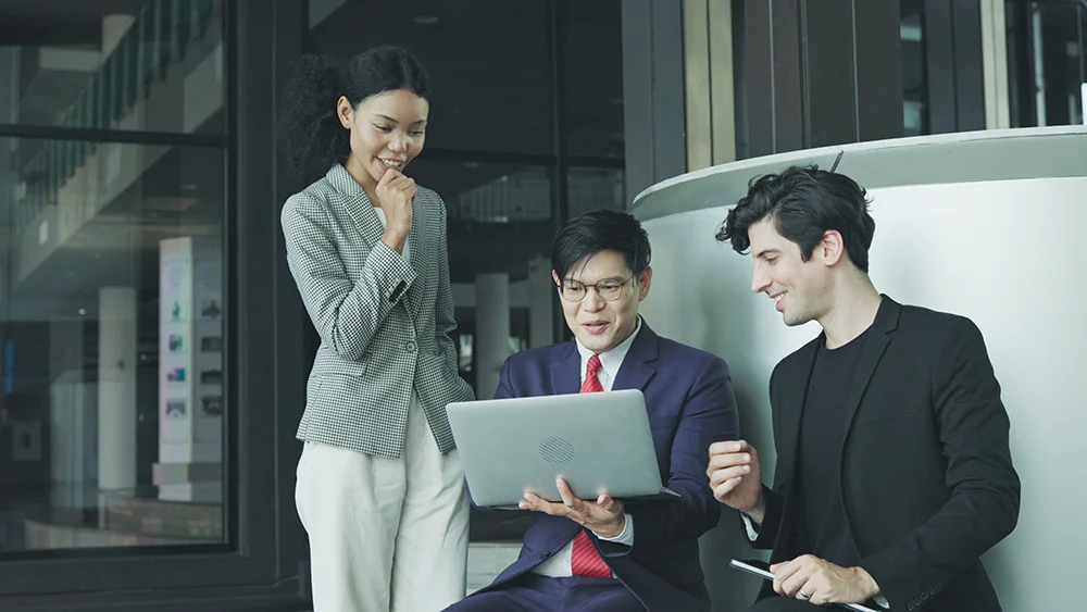 business man in office speaks with staff