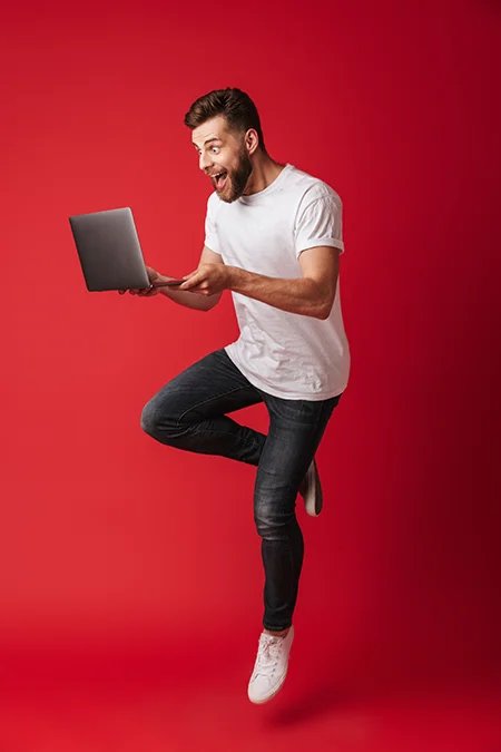 man-reading-computer-synopsis-excited