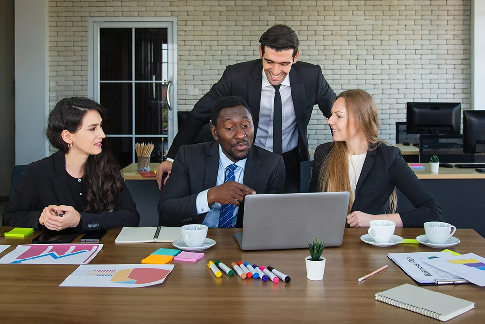 business man in office speaks with staff