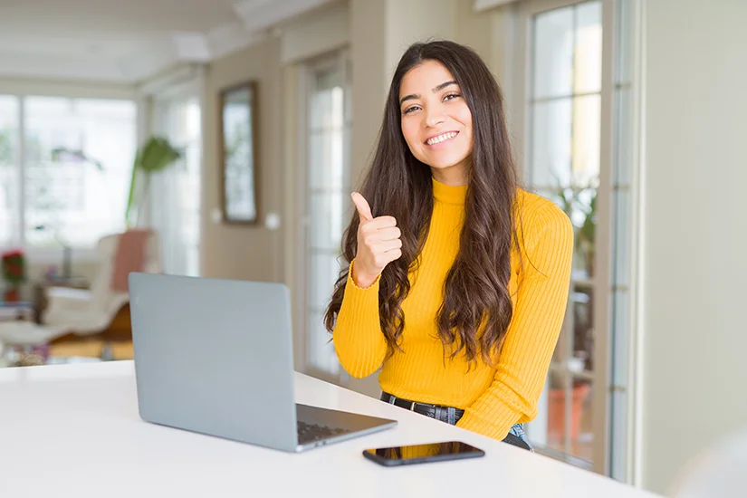 Team member using tech scheduling software on laptop