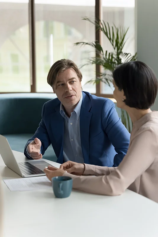 two-female-executives-talking-about-work-computer