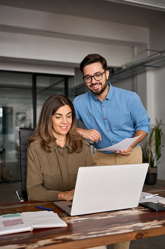 Team collaborating on computer with email attachments open together