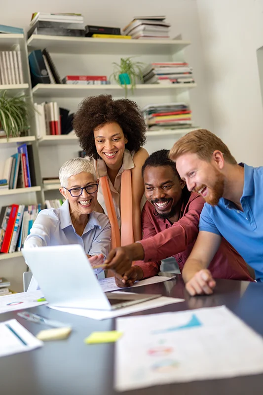 Team collaborating on sales email templates using a computer