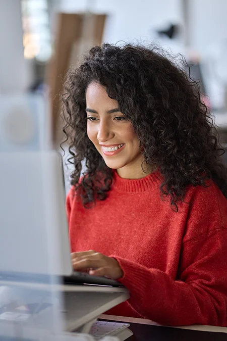 woman happy to use computer from desk