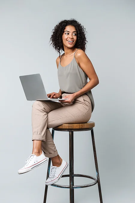 woman-using-computer-sitting-on-chair